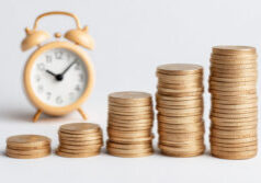 Golden coin stacks with alarm clock represent time investment concept. Money growth through financial planning, savings accumulation, and compound interest. Business wealth building strategy over. Ai generated