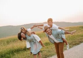 Happy smiling family spending summer day at park.
